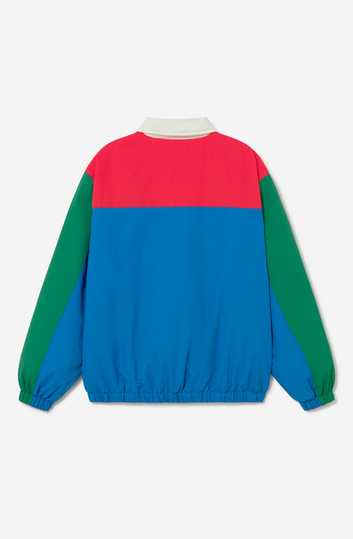 Chaqueta Kangaroo color block azul, verde, rojo y marfil con media cremallera y logo Kaotiko Society.