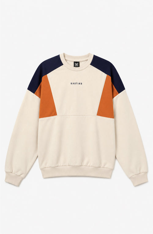 Sudadera unisex Spike de color crudo con paneles naranja y azul marino, cuello redondo y logo Kaotiko en el pecho.