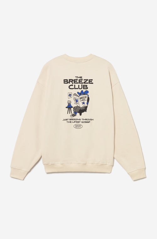Sudadera unisex oversize color ivory con gráfico Kaotiko Society en el pecho y estampado Just Breezing en la espalda.